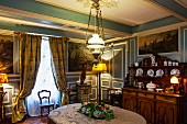 Historic house in Burgundy - dining room with blue and white wood panelling and elegant furnishings