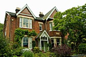 Victorian house built around 1886 with front gables and English brick facade