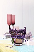 Tealight holder wrapped in lavender sprigs and cord decorating table