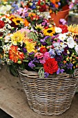 Bouquets of autumn flowers in baskets