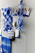 Batik fabrics, dip-dye gift tags and ribbons stuck on wall