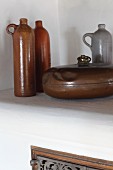 Old stoneware bottles and vintage, metal hot water bottle