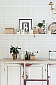 White, shabby-chic dresser and kitchen shelf on grey and white checked wall