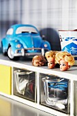 Barbie-doll heads on top of old cabinet with glass storage containers