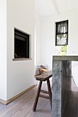 Concrete table and rustic wooden bench in front of open fireplace
