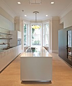 Private Apartment, London, United Kingdom. Architect: Hill Mitchell Berry, 2014. White, monolithic kitchen counter in designer kitchen