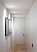 Private Apartment, London, United Kingdom. Architect: Hill Mitchell Berry, 2014. Narrow white hallway with recessed spotlights in suspended ceiling