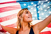 Teenage girl holding American flag
