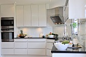 Elegant kitchen with white cabinets and black worksurface