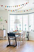 Bunting above dining area in bay window of kitchen-dining room