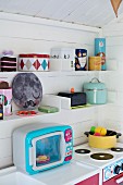 Colourful, retro play kitchen in Scandinavian playhouse