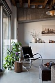 Loft apartment with white sideboard, rocking chair and house plants