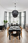 Eclectic, elegant dining room with black and white colour scheme, traditional ambiance and bay window