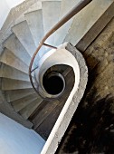 View down stairwell with spiral balustrade and concrete spiral staircase