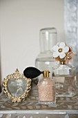 Vintage-style perfume bottles and frames photo on dressing table