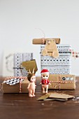 Small Christmas figurines and wrapped presents with gift tags