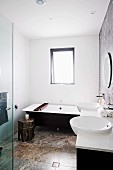 Modern, black and white bathroom with travertine floor, Oriental side table and wooden bathtub tray