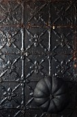 Black pumpkin on metal surface