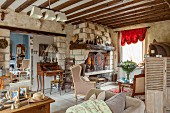 Eclectic furnishing and fireplace in renovated farmhouse