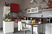 White barstool at breakfast bar in open-plan retro kitchen