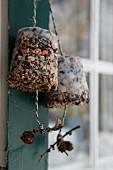 Birdcake moulded in flowerpots and hung up in feeding station