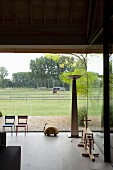 View of horse in paddock through panoramic living room window