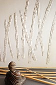 Bamboo canes, Buddha figurine and bamboo relief on wall