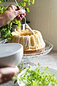 Decorating a bundt cake with white icing