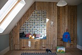 Cubby bed made from recycled wood in boy's bedroom with sloping ceiling