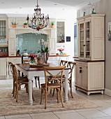 Country-house-style kitchen-dining room with dining set on rug