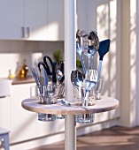 Round minibar with cutlery holders on telescopic pole in kitchen