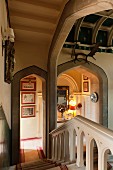 View down staircase in Jacobean manor house with Tudor arches