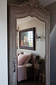 Antique wardrobe with carved pediment and mirrored door