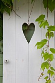 White-painted external door with heart-shaped cut-out