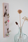 Key hanger hand-crafted from bent vintage cutlery and pastel wooden panel