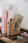 Bookend hand-made from bent vintage fork, various books and washi tape on wooden shelf
