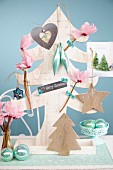 Wooden Christmas tree decorated with cylcamen