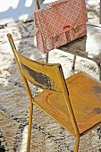 Vintage metal chairs painted different colours on Berber-style rug