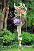 Hand-crafted torch-shaped arrangement of garden flowers