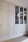 Fitted wardrobes painted white in elegant, country-house style