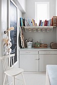 Vintage country-house-style utensils and shelf below window in former pantry