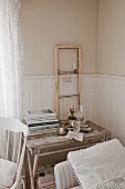 Window frame as shabby-chic decoration on old wooden table with patinated paint