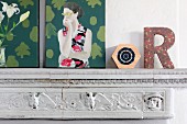 Vintage mantelpiece decorated with modern artworks and decorative letter