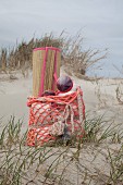 Straw beach mat in crocheted beach bag