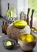 Various containers made from various materials; metal bowl with gilt interior, pouffe and yellow ceramic pot with lid