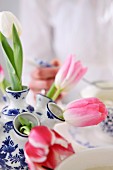 Tulips in blue and white ceramic vase with multiple necks