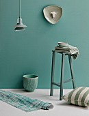 Stool, pendant lamp, ornaments and home textiles in shades of pastel green