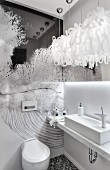 Minimalist washstand with marble counter and artistic wall decoration in white designer bathroom