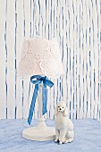 White table lamp with doilies and silk ribbon decorating lampshade
