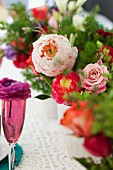 Arrangements of colourful summer flowers decorating table